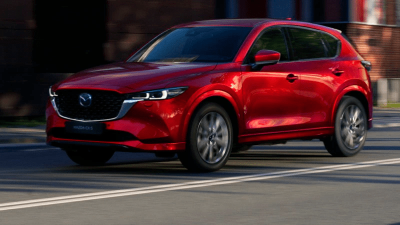 Red 2022 Mazda CX-5 drives down the road
