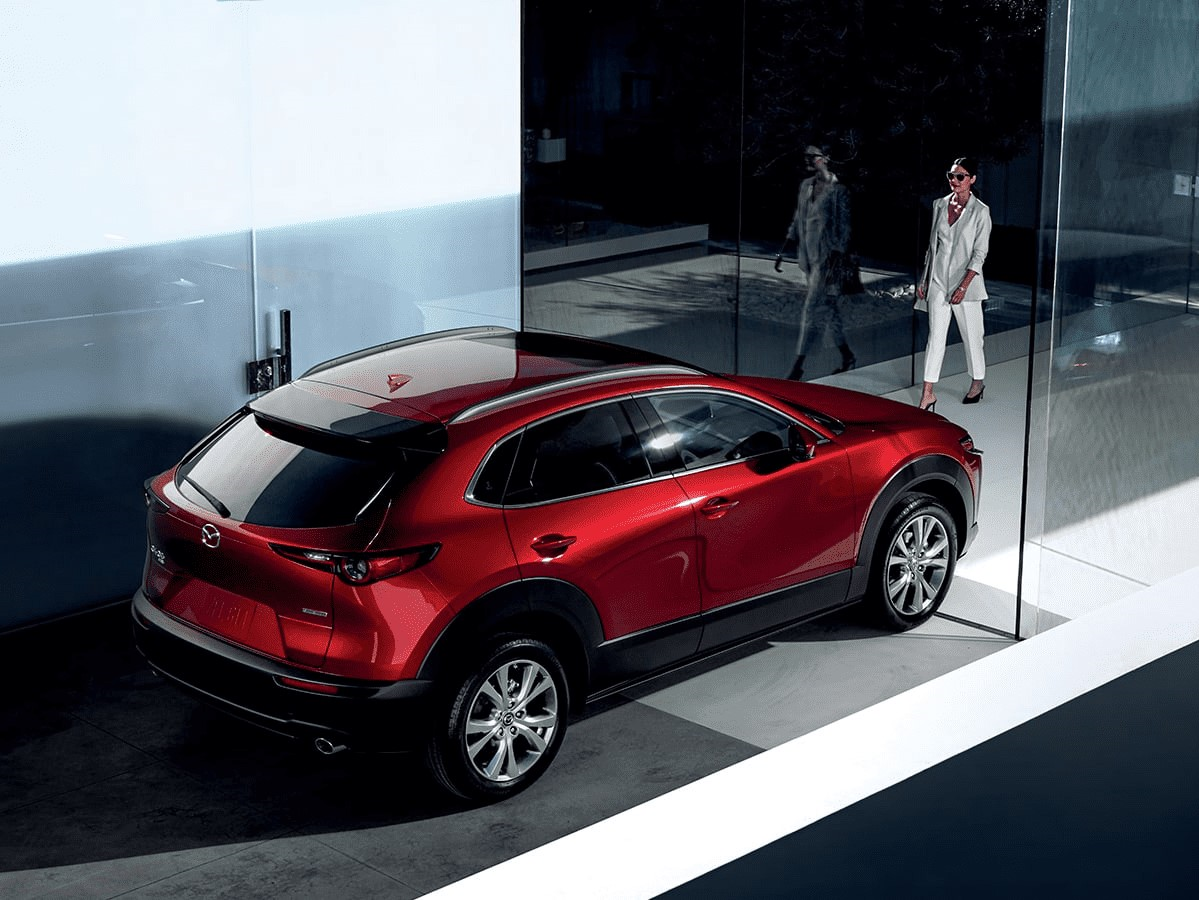 red 2022 Mazda CX-30 in a showroom;