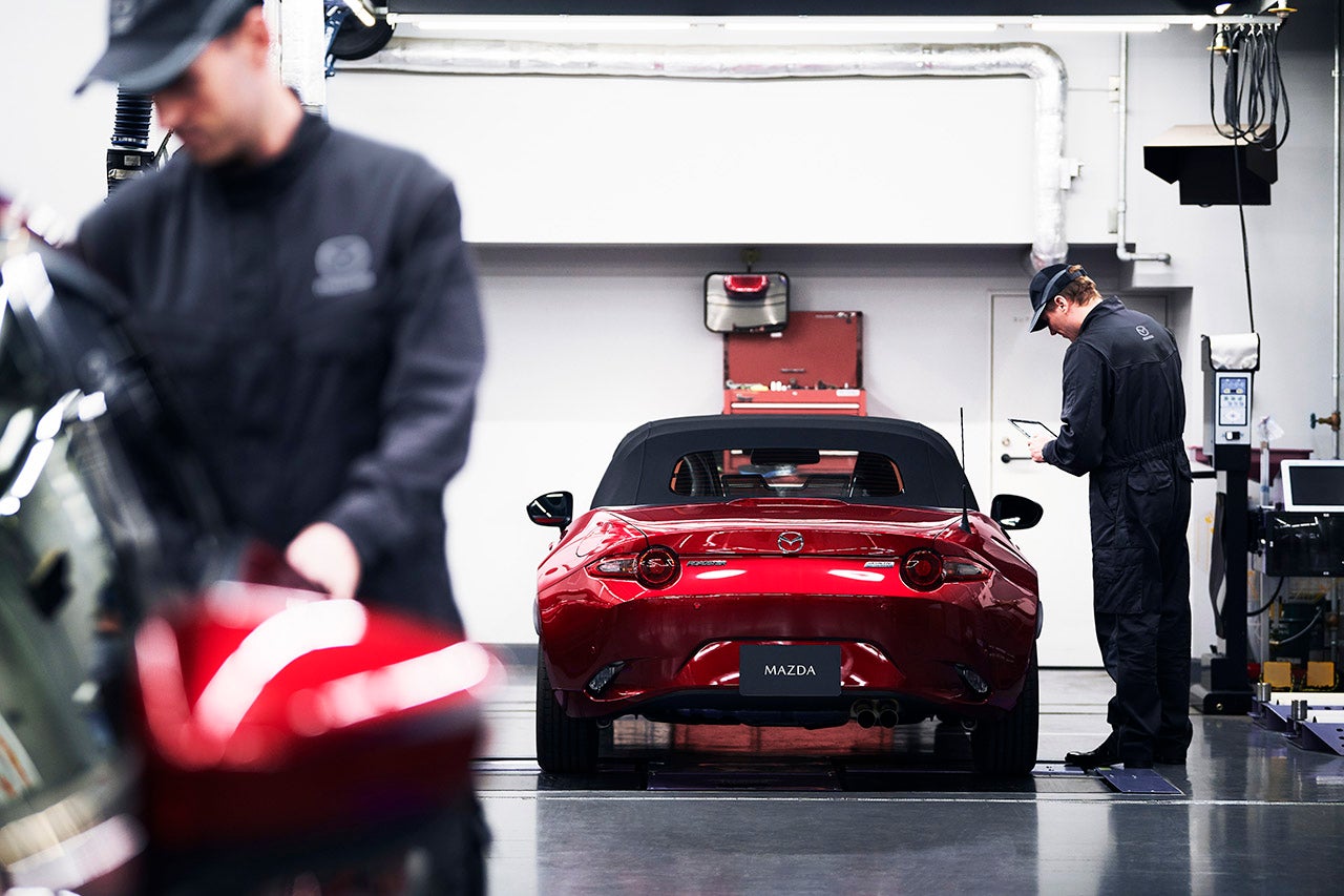 Mazda service technician repairs a Mazda car